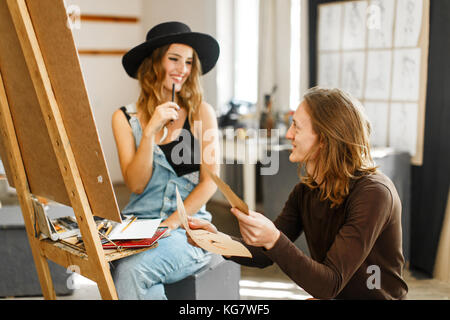 Artist Consult his Colleague while Drawing Stock Photo