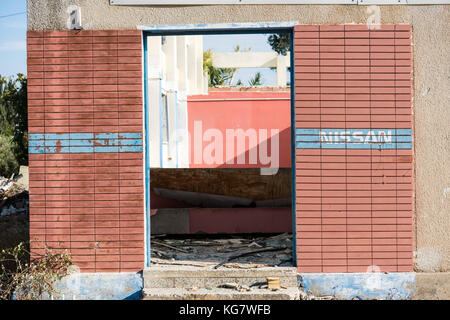 Nissan sign on abandoned industrial building in Larnaca, Cyprus Stock Photo