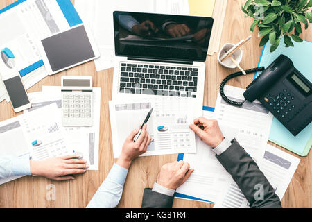 Business team at work, they are analyzing some financial reports and pointing, finance and accounting concept, top view Stock Photo