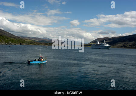 A Langoustine fishing boat heads out into Loch Bloom off Ullapool habour in northwest Scotland, Britain.  Langoustine fishing is big business with man Stock Photo