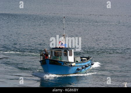 A Langoustine fishing boat on Loch Bloom returns to Ullapool habour in northwest Scotland, Britain.  Langoustine fishing is big business with many of  Stock Photo