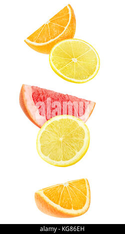 Isolated slices of citrus fruits. Falling pieces of orange, lemon and grapefruit isolated on white background with clipping path Stock Photo