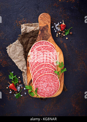 Italian salami sausage on wooden board. Stock Photo