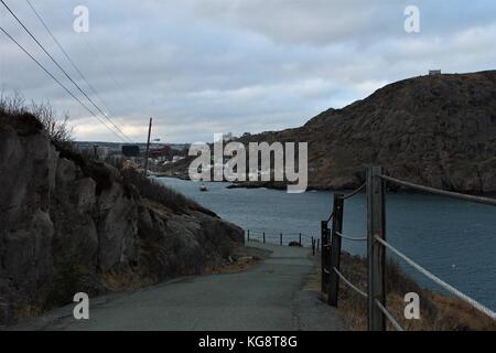 Road leading out of Fort Amherst, on the South Side of St. John's Harbour, looking across at the city of St. John's, Newfoundland, and the Battery. Stock Photo