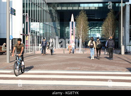 Young people at Turfmarkt Street walking towards The Hague Central Station, The Hague, The Netherlands