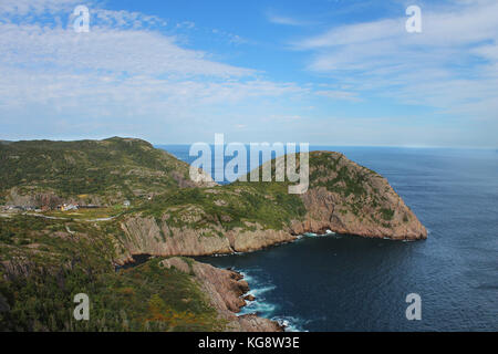 Steep, rocky cliffs along the coastline, St. John's, Newfoundland. Panoramic view of the ocean and hilly coastline. Stock Photo