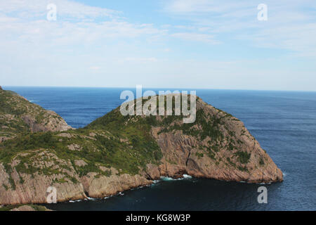 Steep, rocky cliffs along the coastline, St. John's, Newfoundland. Panoramic view of the ocean and hilly coastline. Stock Photo