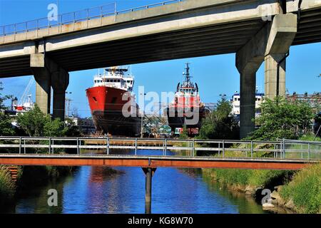 Looking down the Waterford River toward St. John's Harbour where two ships are in dry dock, St. John's, Newfoundland Stock Photo