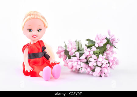 Baby doll and pink flowers. Stock Photo