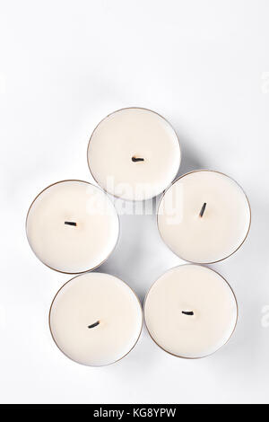 Five small round candles, top view. Stock Photo