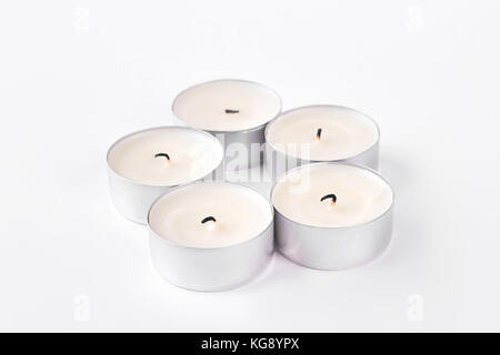 Set of five round tea light candles. Stock Photo