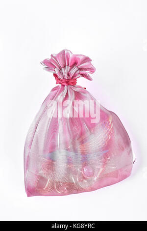 Pink organza bag with jewelry. Stock Photo