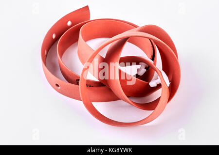 Red medical tourniquet, white background. Stock Photo