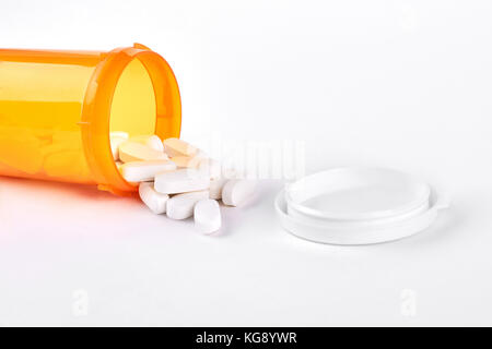 White pills spilled from pills bottle. Stock Photo