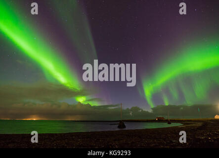 Northern lights Aurora Borealis above landscape in Iceland Stock Photo