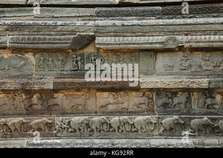 Carving details on the outer wall of Mahanavami Dibba. Pyramidal three tiered 8 meter high stone platform made from granite. Hampi. Karnataka, India Stock Photo