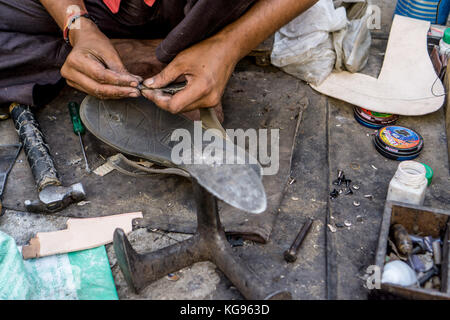 The Blue City - Having my sandal repaired Stock Photo