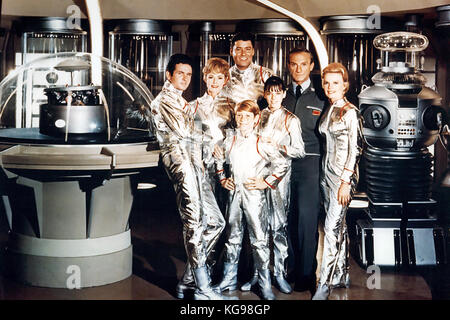 LOST IN SPACE American CBS TV series 1965-68. From left: Guy Williams,  June Lockhart,  Mark Goddard,  Billy Mumy, Angela Cartwright,  Jonathan Harris  and Marta Kristen  with the Class M-3 Model B9, General Utility Non-Theorizing Environmental Control Robot Stock Photo