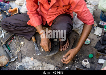The Blue City - Having my sandal repaired Stock Photo