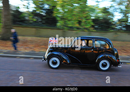 London, UK. 5th Nov, 2017.  A 1955 Ford Popular driving along Constitution Hill, central London, during the annual Bonhams London to Brighton Veteran Car Run. The driver and their passenger were wearing masks of Prince William and Catherine, Duchess of Cambridge. 454 Pre-1905 manufactured vehicles took part in this year's run which happens on the first Sunday of every November and commemorates the original Emancipation Run of 14 November 1896. Credit: Michael Preston/Alamy Live News Stock Photo