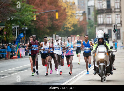 New York, USA. 05th Nov, 2017. Elite mens's runners pass through Harlem in New York near the 22 mile mark near Mount Morris Park on Sunday, November 5, 2017 in the 47th annual TCS New York City Marathon. Geoffrey Kamworor of Kenya, center, won the marathon in 2 hours, 10 minutes and 53 seconds. ( © Richard B. Levine) Credit: Richard Levine/Alamy Live News Stock Photo