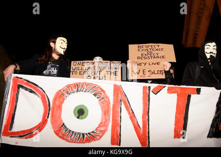 London, UK. 5th Nov 2017. Million Mask March demonstration organized by Anonymous inspired activists. Masked protesters are holding a placards reading 'Respect Existence or Expect Resistance. They live, we sleep', 'One day the poor will have nothing to eat but the rich'. Trafalgar Square, London, UK. Credit: ZEN - Zaneta Razaite / Alamy Live News Stock Photo