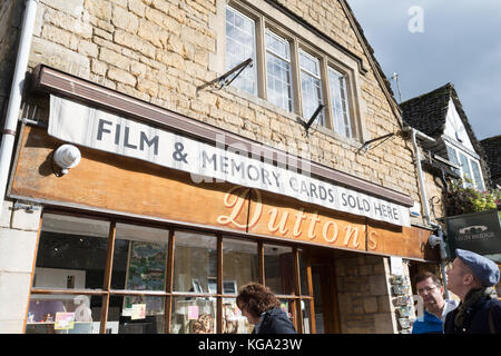 Tourists and photography - 'Film and Memory Cards Sold Here' sign in the popular tourist Cotswold village of Bourton on the Water, England, UK Stock Photo