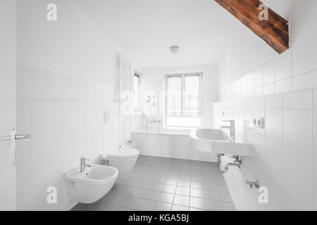 white bathroom - modern tiled bath bathtub Stock Photo