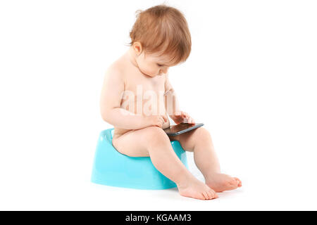 kid with a phone on the potty Stock Photo