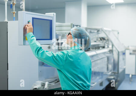 operator in the pharmaceutical factory near the equipment Stock Photo