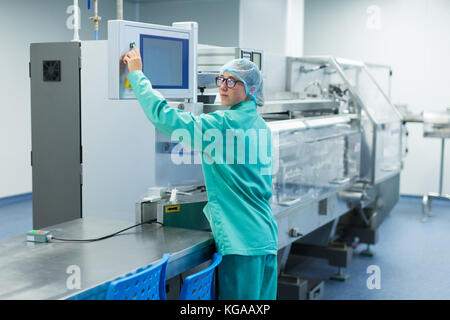 operator in the pharmaceutical factory near the equipment Stock Photo