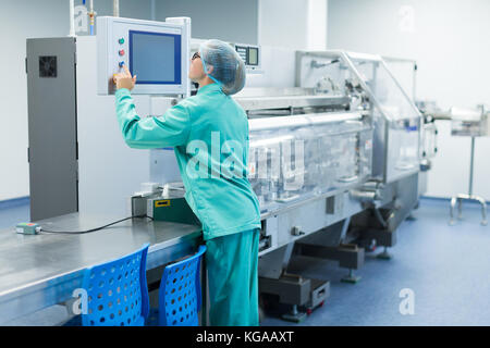 operator in the pharmaceutical factory near the equipment Stock Photo