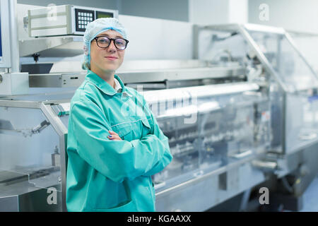 operator in the pharmaceutical factory near the equipment Stock Photo