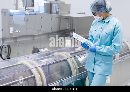 science worker is making notes in tablet Stock Photo