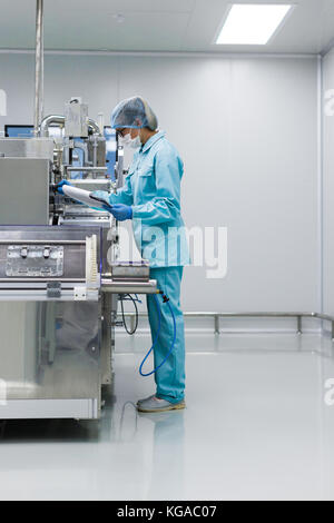scientist is making notes about machine Stock Photo