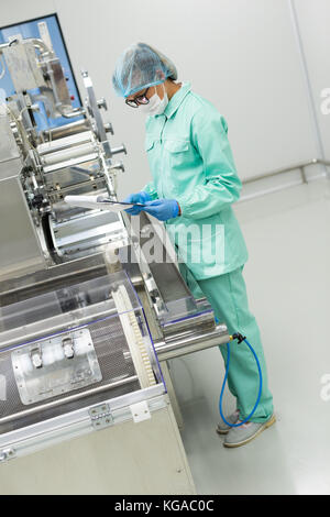 factory worker fix machine Stock Photo