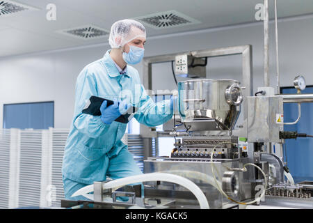 scientist making notes about machine Stock Photo