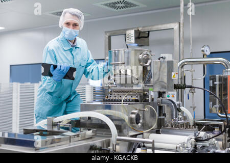 scientist making notes about machine Stock Photo