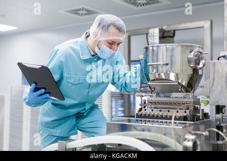 scientist making notes about machine Stock Photo