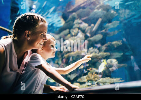 Mother and son watching sea life in oceanarium Stock Photo