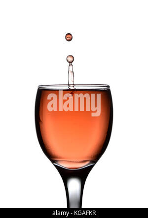 Cherry juice drop splash in crystal wine glass Stock Photo