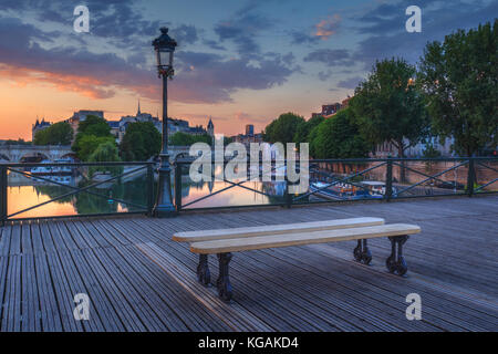 Sunrise over Paris, France with Pont des Arts and the river Seine. Colourful skyline with dramatic clouds. Stock Photo