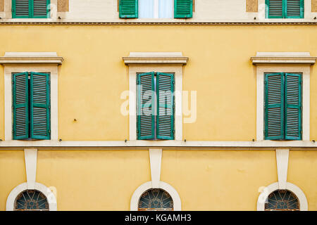 Pattern from windows of the facade of one of the buildings in Rome, Italy Stock Photo