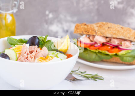 Tuna salad and tuna sandwich with vegetables, egg and olives. Stock Photo