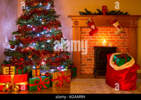 A living room on Christmas Eve with presents under the tree, a mince pie and glass of milk on the fireplace waiting for Santa. Stock Photo