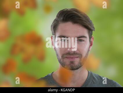 Digital composite of Man's face in forest with leaves Stock Photo