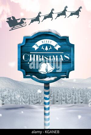 Digital composite of Merry Christmas text on Wooden signpost in Christmas Winter landscape and Santa's sleigh and reindee Stock Photo