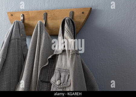 Close-up of denim jacket hanging on hook Stock Photo