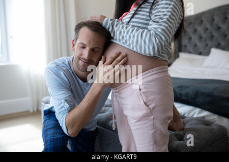 Man feeling the presence of baby in bedroom Stock Photo