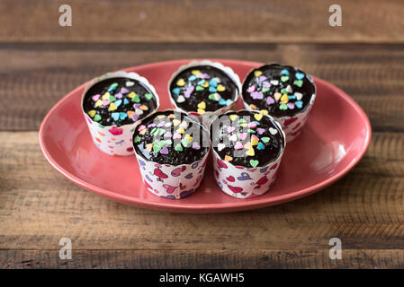 homemade cupcakes in plate on a wooden table Stock Photo